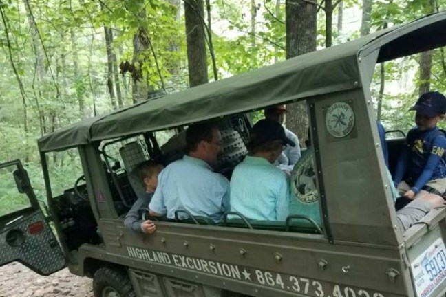 a group of people riding on the back of a truck