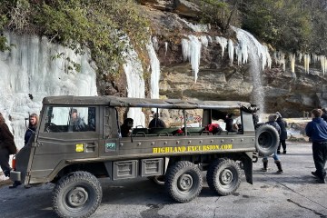 a group of people riding on the back of a truck