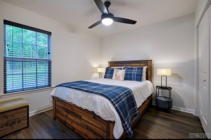 a bedroom with a bed and desk in a room