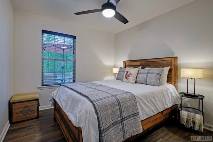 a bedroom with a bed and desk in a room