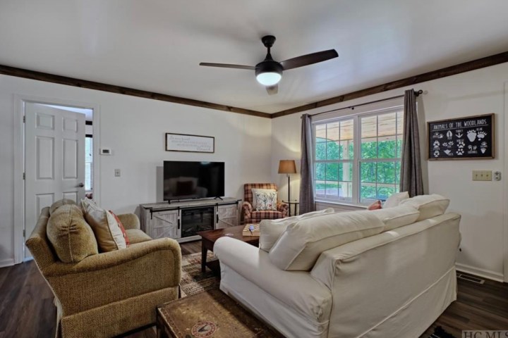 a living room filled with furniture and a large window