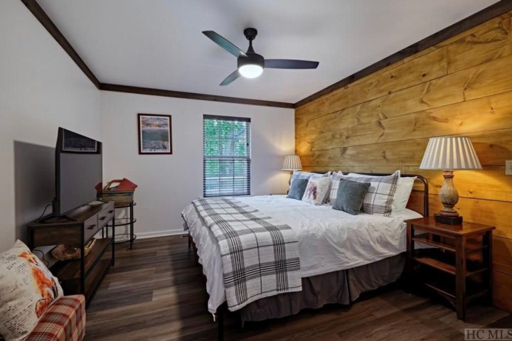 a bedroom with a bed and desk in a room