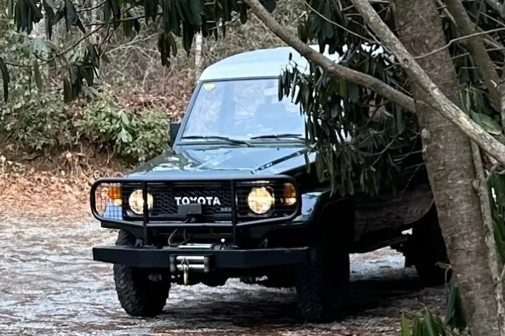 a car parked in front of a truck